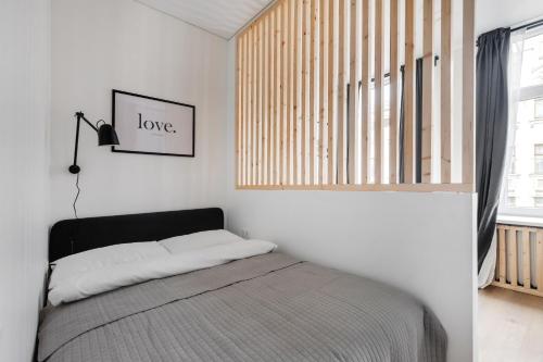 a bedroom with a bed and a window at Hook Studios Vilnius Old Town in Vilnius