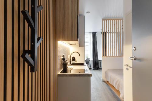 a kitchen with a sink and a bed in a room at Hook Studios Vilnius Old Town in Vilnius