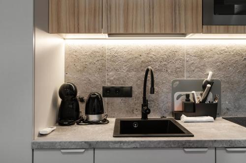 a kitchen counter with a sink and a mixer at Hook Studios Vilnius Old Town in Vilnius