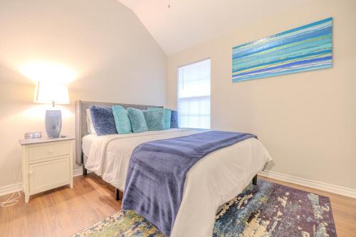 a bedroom with a bed with blue pillows and a window at Oasis - Indoor Swimming Pool in The Colony