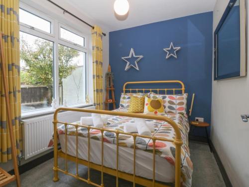 a bedroom with a bed with stars on the wall at Trearddur House Cottage in Holyhead