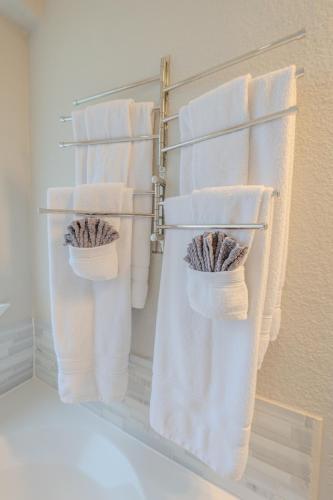 a group of towels hanging on a rack in a bathroom at Oasis - Indoor Swimming Pool in The Colony