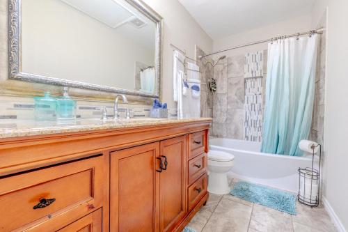 a bathroom with a sink and a tub and a toilet at Oasis - Indoor Swimming Pool in The Colony