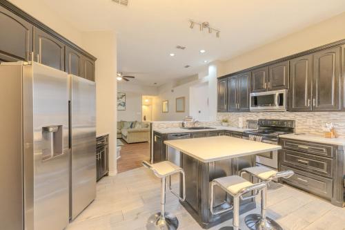 a kitchen with wooden cabinets and stainless steel appliances at Oasis - Indoor Swimming Pool in The Colony