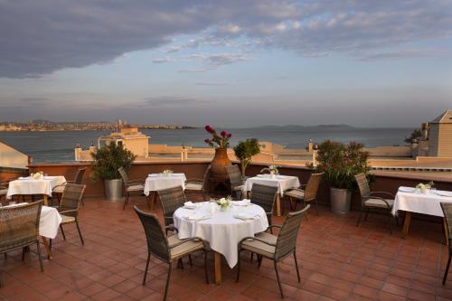 a restaurant with tables and chairs and a view of the ocean at Armada Istanbul Old City Hotel in Istanbul