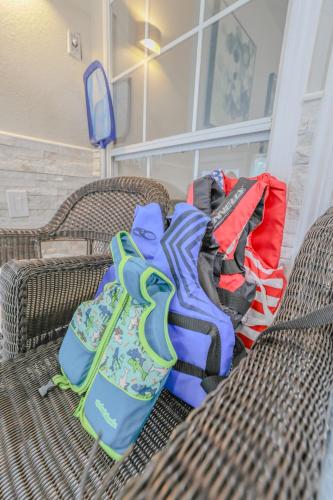 a group of bags sitting on two wicker chairs at Oasis - Indoor Swimming Pool in The Colony