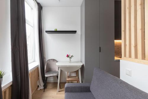 a small room with a table and a chair at Hook Studios Vilnius Old Town in Vilnius