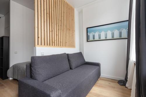 a living room with a couch and a picture on the wall at Hook Studios Vilnius Old Town in Vilnius