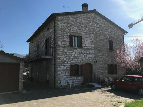 an old stone building with chairs in front of it at Casa delle Sirene in Perugia