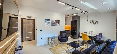 a living room with a couch and a table at ERA NRG Luxury Apartment Pleven in Pleven