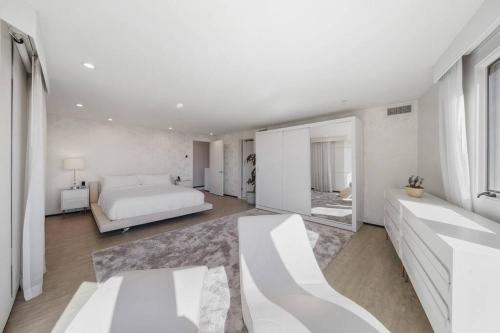 a white bedroom with a bed and a couch at Wander Malibu Canyon in Malibu Beach