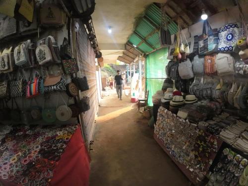 a shop with a bunch of bags and other items on the wall at Om Ganesh Guest House Cliffside in Arambol