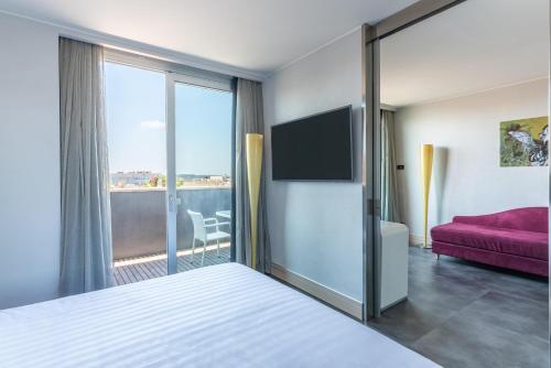 En eller flere senge i et værelse på Best Western Premier Hotel Royal Santina