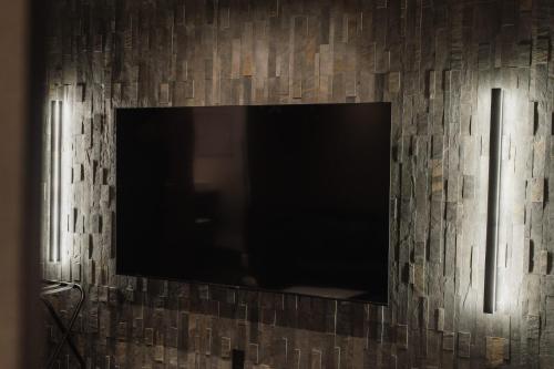 a flat screen tv hanging on a wall at The LOFT INN HAKATA in Fukuoka