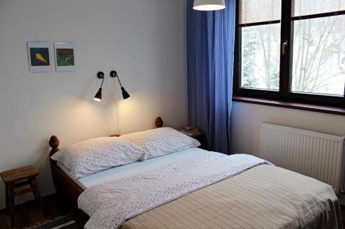 a bedroom with a bed and a window at Apartment Polianka in Vysoke Tatry - Horny Smokovec