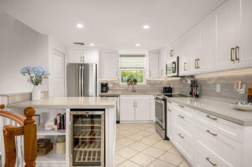 a kitchen with white cabinets and a refrigerator at Exquisite Yacht Club Townhome in The Bight Settlements