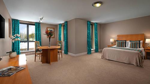 a bedroom with a bed and a table with a table sidx sidx sidx at Great National South Court Hotel in Limerick