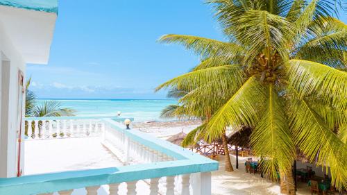 a view of the beach from the balcony of a house at Sands Inn Hotel in Pwani Mchangani