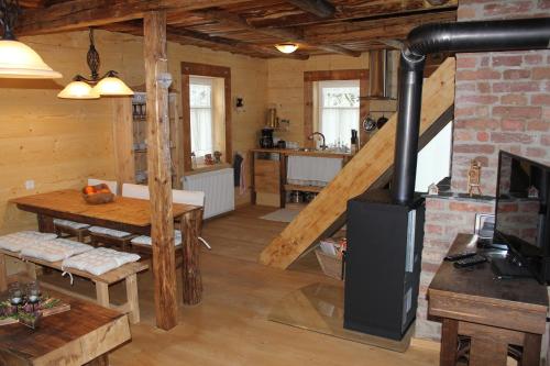 a kitchen and living room with a wood stove at Ferienhaus Anno Dazumal, wie zu Oma`s Zeiten in Klingenthal