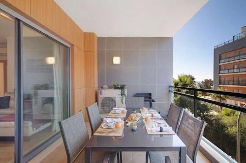 a dining room with a table and chairs on a balcony at MyOasis II - Algarve in Olhão