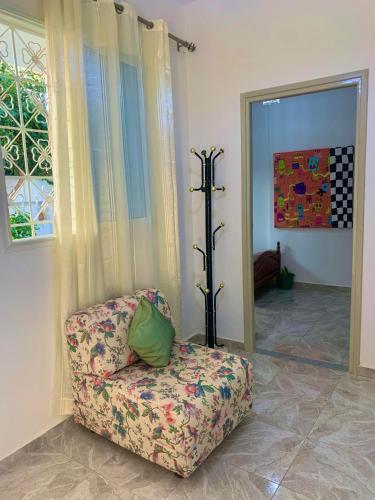 a living room with a chair with a pillow on it at Bardo centre in Le Bardo