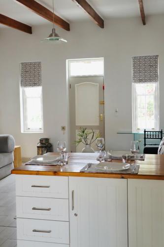 a kitchen counter with two sinks and a mirror at River Bend Guesthouses in Graaff-Reinet