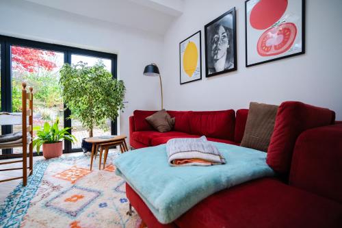 a red couch in a living room with a table at Acer View in Leeds