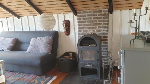 a living room with a couch and a fireplace at Amazing Home In Ebeltoft With 2 Bedrooms And Wifi in Ebeltoft