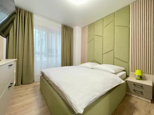 a bedroom with a large bed and a window at Apartment No 604 Central Residence in Bucharest