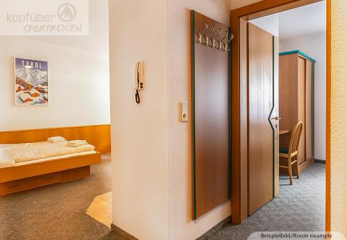 a room with a door to a bedroom with a bed at Apart Tirolerland in Ischgl