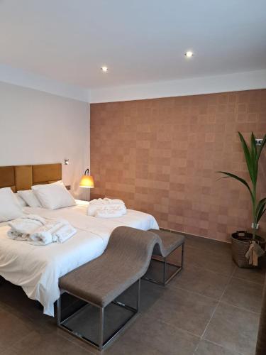 a bedroom with two beds and a potted plant at HC LUXURY CELAVELLa in Playa Blanca