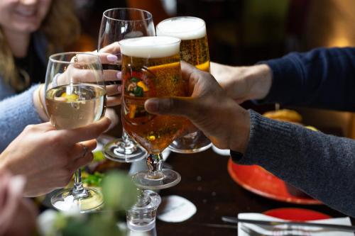 a group of people holding up glasses of beer at Great National South Court Hotel in Limerick