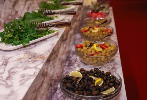 a buffet with bowls of food on a table at The Hera Platinum Hotel in Istanbul