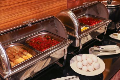 a buffet with two trays of food and eggs at The Hera Platinum Hotel in Istanbul