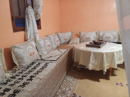 a living room with a couch and a table at Adil Guest House in Nzala