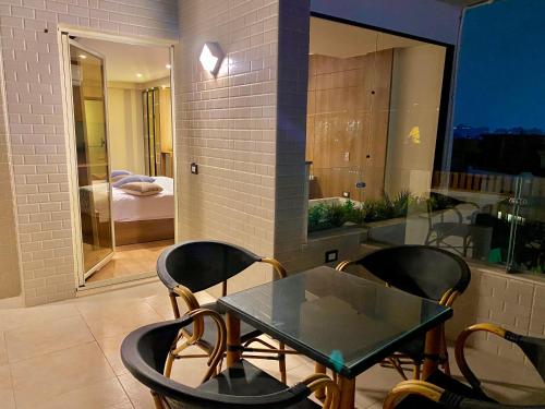 a dining room with a glass table and chairs at New Museum Guest House, Pyramids View in Cairo