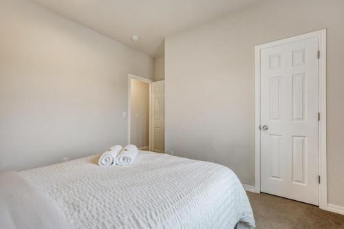 a bedroom with a bed with two towels on it at Orchid Oasis - 2 Kings Foosball BBQ Fire Pit in Colorado Springs