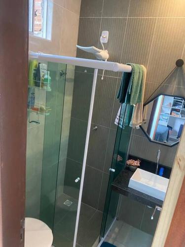 a bathroom with a glass shower with a toilet at AP a 5 minutos do aeroporto ótima localização in Bayeux