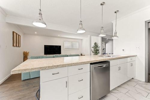a kitchen with white cabinets and a counter top at Newly Renovated 6BR 3BA Port Arthur Holiday Home with Hot Tub in Port Arthur