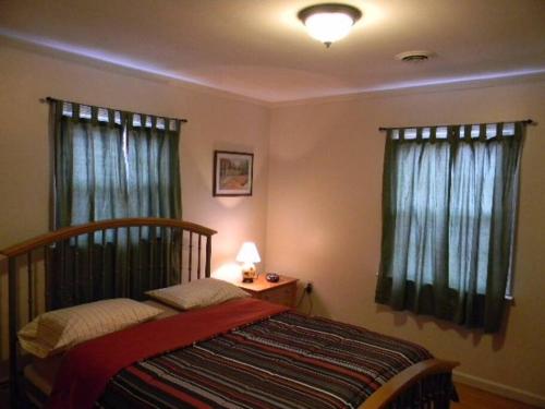 a bedroom with a bed and two windows at Welcome to the Wildwoods Hershey PA in Manor Acres