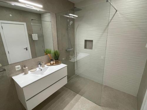 a bathroom with a white sink and a shower at Praia Village AG in Vilamoura