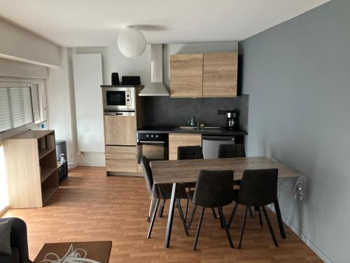 a kitchen and dining room with a table and chairs at Grand studio centre ville St Pierre in Cholet