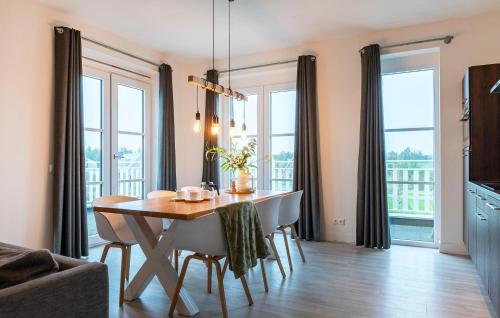 a dining room with a table and some windows at Awesome Apartment In Kamperland in Kamperland