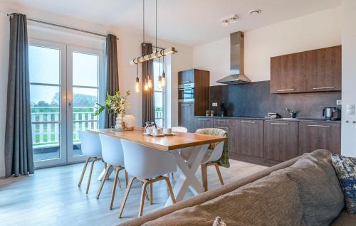 a kitchen and living room with a table and chairs at Awesome Apartment In Kamperland in Kamperland