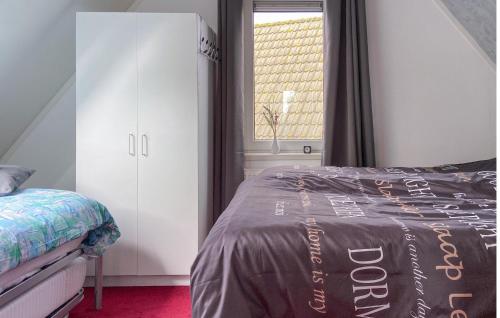 a bedroom with a bed and a window at Pet Friendly Home In Opperdoes in Opperdoes