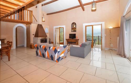 a living room with a couch and a fireplace at 4 Bedroom Lovely Home In Azilone Ampaza in Azilone-Ampaza