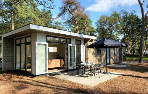 a small house with a table and chairs at Amazing Home In Hellendoorn With Sauna in Hellendoorn