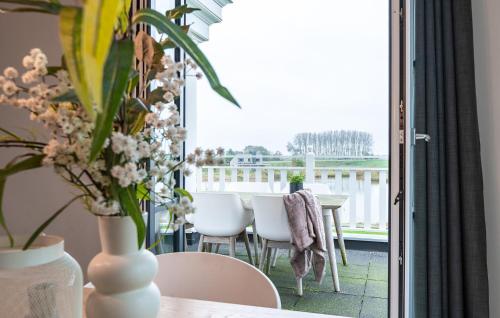 a room with a table and chairs and a balcony at Awesome Apartment In Kamperland in Kamperland