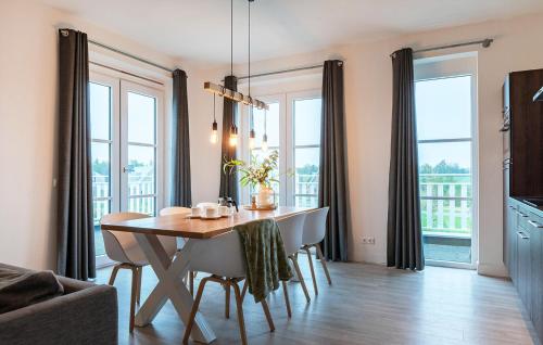a dining room with a table and some windows at Awesome Apartment In Kamperland in Kamperland