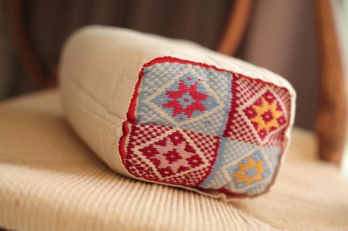 a pillow sitting on top of a couch at Navela Hotel & Convention in Ratchaburi